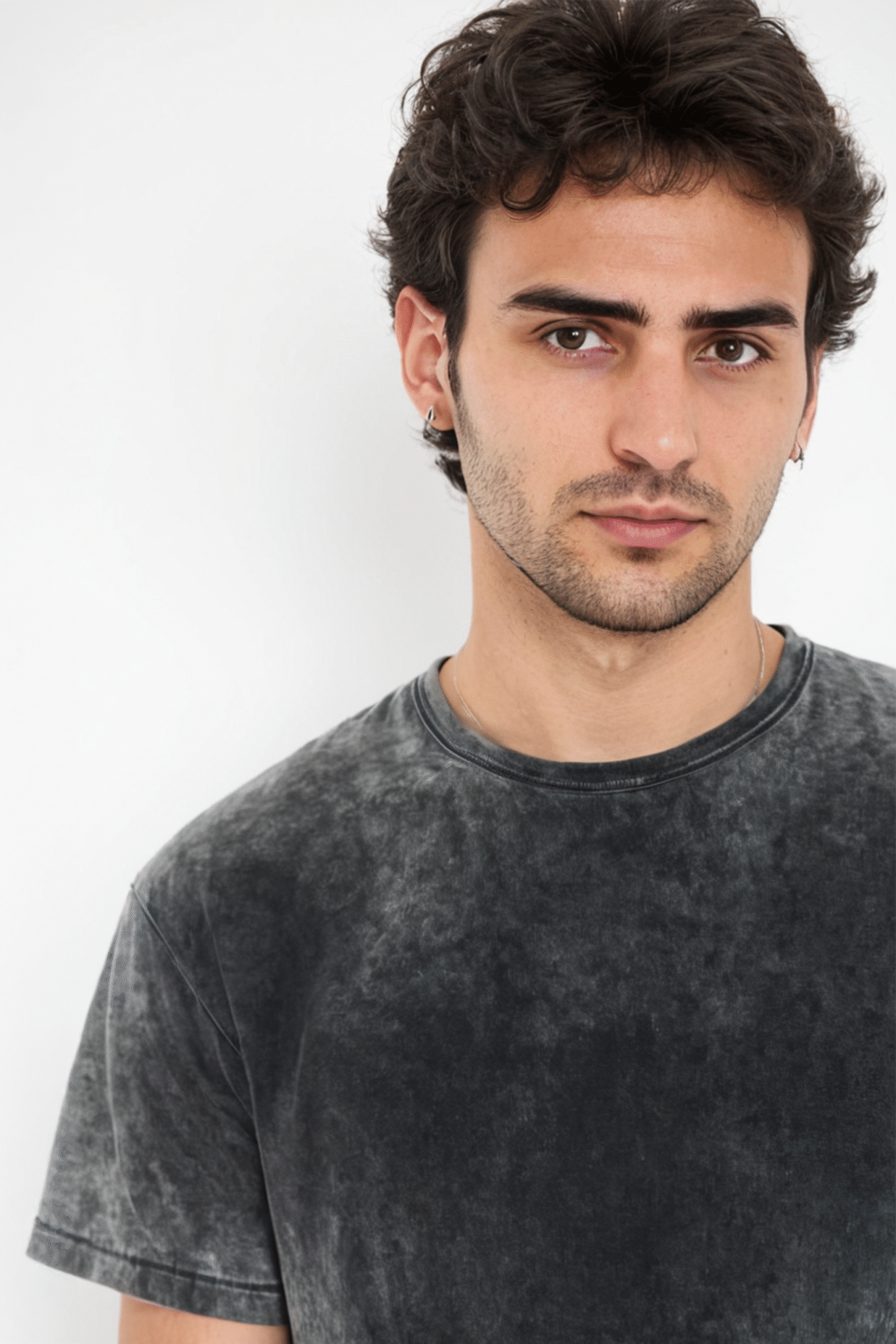 A solid black acid wash oversized T-shirt with a trendy and vintage-inspired look, ideal for casual and streetwear fashion.