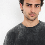 A solid black acid wash oversized T-shirt with a trendy and vintage-inspired look, ideal for casual and streetwear fashion.